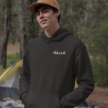 Man wearing black hoodie with Nalle logo camping.
