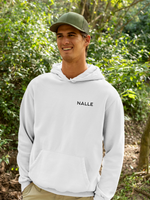 Man wearing a gray hoodie with the Nalle logo on hiking in a forest.