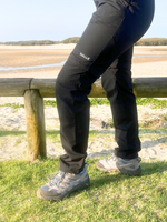 Woman wearing black hiking pants hiking on the beach