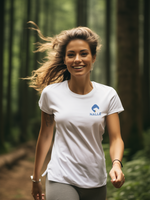 Woman wearing a white t-shirt with the Nalle logo on hiking in the forest